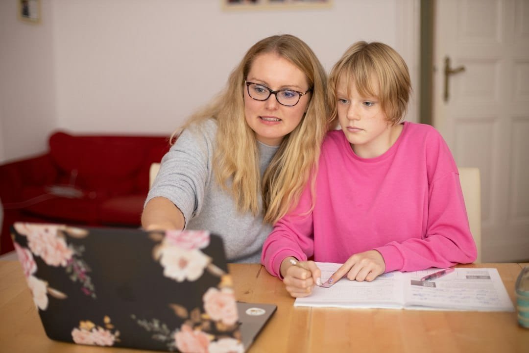 Parent and student studying with a laptop